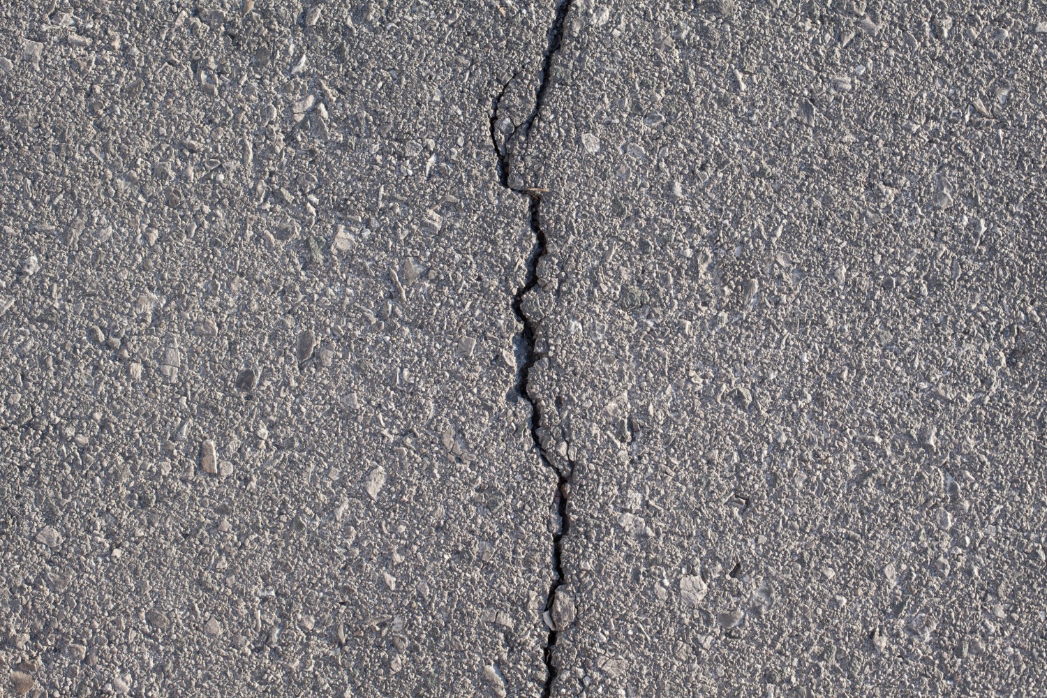 Cracked asphalt road needing repair